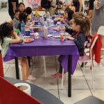 Children exploring artistic expression with vibrant drawings during the Kids' Art Party.